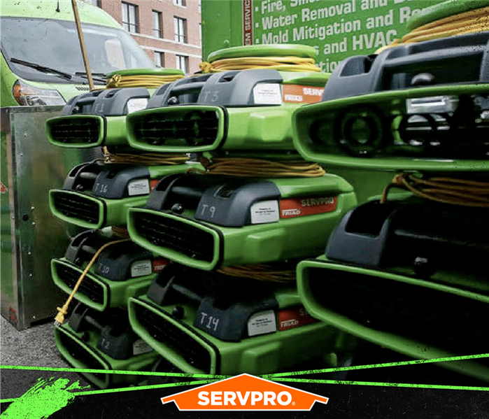 stacks of drying devices servpro poster