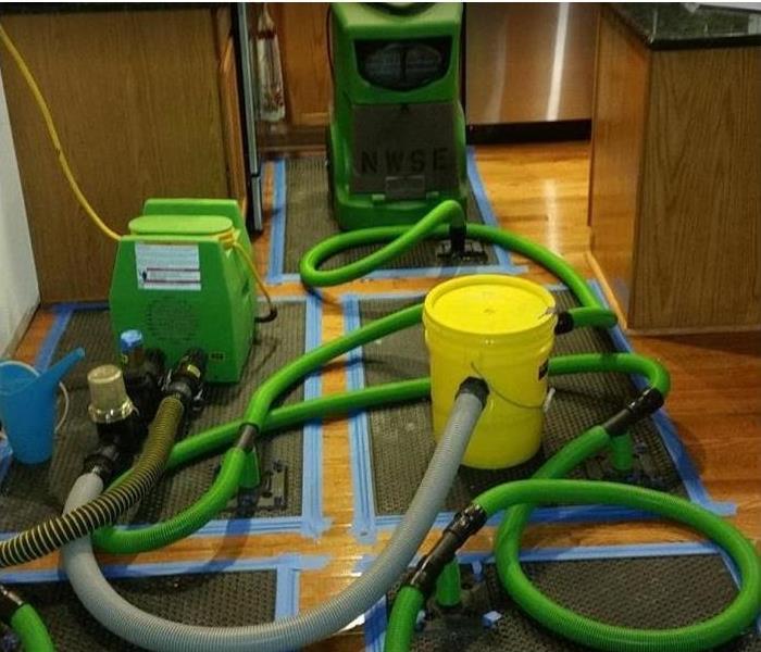 SERVPRO restoration equipment being used on kitchen floor