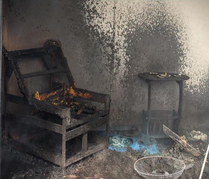 chair and furniture in room after burned in burn scene of arson investigation course