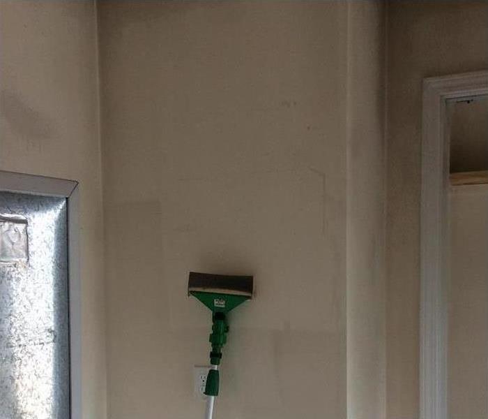 One of our cleaning equipments cleaning the wall in this property after a fire