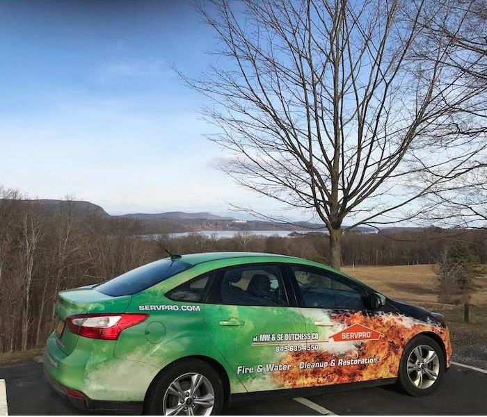 SERVPRO car in a parking lot overlooking a lake